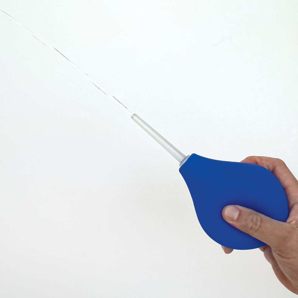 Blue Skwert douche bulb held in one hand with a translucent wand attached